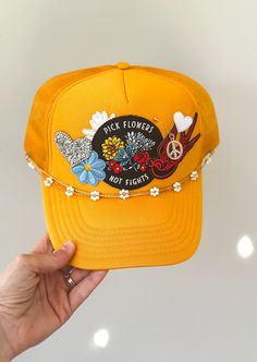 Golden yellow patched trucker hat with a removable floral chain and hat pin with charm.  Hat is a tradional trucker hat with mesh and snapback adjustment. Hat With Patches, Hat Chain, Pick Flowers, Custom Patch, Custom Trucker Hats, Free Bird, Patch Hat, Hat Patches, Custom Patches