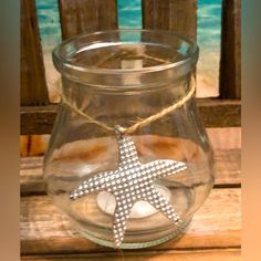 a starfish in a glass jar on a wooden table