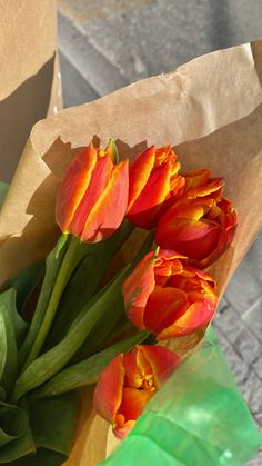 orange and yellow tulips in a brown paper bag