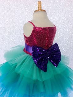 Gorgeous Trolls-inspired dress with mermaid colors with puffy ruffles makes this the perfect gown for any little girl! Handcrafted with the upmost of care and attention to detail, we make sure that each dress is perfectly one of a kind. The sparkly sequence spaghetti strap bodice is fully lined for comfort. Comes with a detachable satin ribbon belt for an adjustable fit. A detachable sequin bow comes with the dress as well for some additional shimmer. The skirt is made out of multiply colored st Recital Photoshoot, Photoshoot Birthday, Newborn Flower, Fall Birthday Parties, Ruffle Gown, Dress Bow, Toddler Easter, Toddler Halloween, Mermaid Coloring