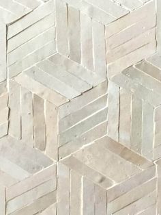 a close up view of white marble tiles