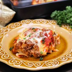 a close up of a plate of food with lasagna