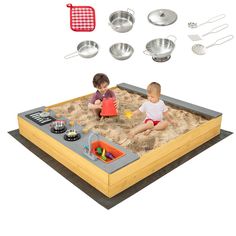 two children playing in a sandbox with cooking utensils