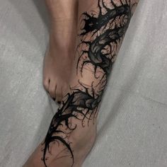 a woman's bare foot with black ink on it