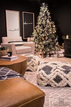 a living room filled with furniture and a christmas tree in the middle of the room