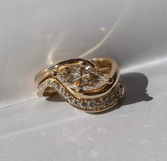 a close up of a gold ring with diamonds on it