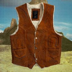 Vintage / Handmade - Brown Suede Wool Trimmed Vest - Antique Western Vintage Handmade Brown Soft Leather Suede Vest With Wool Trim And Hand Engraved Design Beautiful Engraved Western Design On Front And Back 2 Side Pockets On Front + Snaps Closed Never Worn Antique Vintage Circa ~ 1975 Soft Suede + White Wool There Is No Size Label - I Have The Measurements Listed Below! I Haven’t Used A Leather Cleaner/Conditioner On It, So The Color Is Slightly Faded, Other Than That There Are No Flaws, Rips, Fitted Western Vest For Winter, Fitted Western Style Winter Vest, Vintage Winter Vest Outerwear, Brown Winter Outerwear For Rodeo, Bohemian Fall Vest Outerwear, Bohemian Vest Outerwear For Fall, Fitted Western Vest Outerwear, Fitted Western Style Vest Outerwear, Fitted Western Style Outerwear Vest