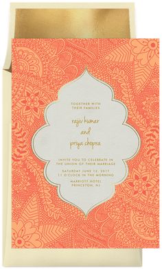 an orange and white wedding card with gold foil on the front, featuring a floral design