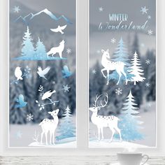 the window is decorated with winter scenes and deers, birds, and snowflakes