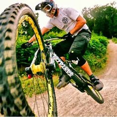 a man riding a bike down a dirt road