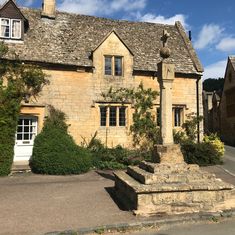 an old house with stone steps leading up to it