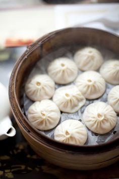 some dumplings are sitting in a bowl on a table