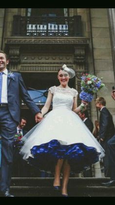 a man and woman are walking down the stairs