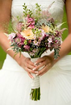 a bride holding a bouquet of flowers in her hands