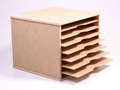 a stack of cardboard boxes sitting on top of a white table next to each other