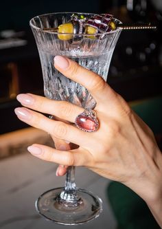 18.5 carats of a purplish pink Tourmaline cabochon from Brazil come together to form a one-of-a-kind cocktail ring, inspired by speakeasy bar vibes and reminiscent of a glass of rosé wine. Crafted by a family jewelry smith in Taipei, Taiwan 20 years ago, this stunning ring is guaranteed to be a true showstopper. Metal: this ring we offer white gold vermeil crafted with pure sterling silver. If you prefer to upgrade to 18k solid white or yellow gold, please send us a request, and we will provide you with the price for the item made with 18k solid gold. Gemstone: Pink Tourmaline Origin: Brazil Color: purplish pink Transparency: transparent  Treatment: natural color, not treated Stone weight: 18.5 ct Total weight: 11.2 Ring Size : size 7 (Able to resizing, please contact us) Feel free to mess Luxury Heirloom Tourmaline Jewelry, Luxury Pink Amethyst Ring For Gift, Luxury Pink Amethyst Ring As Gift, Oval Ruby Ring For Party, Oval Ruby Ring For Parties, Luxury Pink Amethyst Ring For Formal Occasions, Luxury Tourmaline Cabochon Rings, Elegant Pink Ruby Cabochon Ring, Elegant Pink Cabochon Ruby Ring