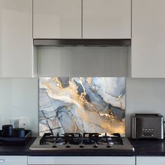 a stove top oven sitting inside of a kitchen next to a microwave and toaster