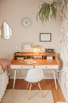 a white desk with a clock on the wall above it