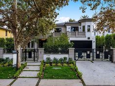 this is an image of a house in the suburbs with trees and bushes around it