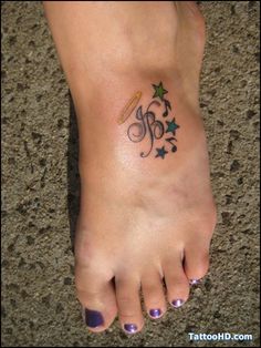 a woman's foot with a small tattoo on her left ankle and stars around it