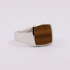 The craftsman that makes this ring is on vacation, so it is currently unavailable. Sterling silver men's ring with a Tiger's eye stone. This ring is handmade by a family run business of highly skilled craftsmen. It's quality and finish are second to none. Top grade Tiger's eye stone is used. Tiger's eye is often associated with the astrological signs of Leo and Capricorn. It is believed to enhance the traits of these signs, such as leadership, courage, and discipline. Stone: Tiger's Eye. Stone s Leo And Capricorn, Sterling Silver Mens Rings, Wolfram, Mens Silver Rings, Tiger Eye Stone, Eye Ring, Sterling Silver Mens, Eye Stone, Ring Sizes