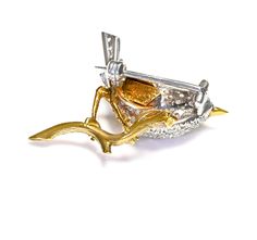 Tiffany & Co. Gold Diamond Sapphire Bird This exquisite Tiffany & Co. brooch captures the delicate beauty of a bird perched on a branch, meticulously crafted from 18K gold. The bird is adorned with sparkling diamonds, creating a striking contrast with the vivid blue sapphire that form its eye. The branch is artistically rendered to look lifelike, enhancing the overall naturalistic theme. This piece combines the timeless elegance of gold and diamonds with the colorful allure of sapphires, making Elegant Bird Design Brooches For Gift, Montblanc Pen, Costume Jewelry Earrings, Delicate Beauty, Belt Purse, Silver Enamel, Sparkle Diamonds, Jewelry Rings Engagement, Tiffany & Co.