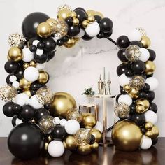 black, white and gold balloon arch