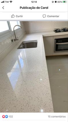 a white counter top in a kitchen next to a stove and sink with an oven