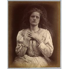 an old photo of a woman with her hands on her chest and wearing a hat