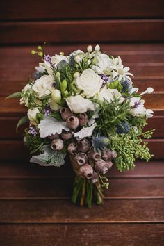 a bouquet of flowers sitting on top of a wooden table