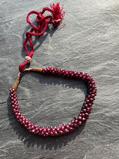 A lovely garnet chip Indian vintage necklace this one is a vintage piece on a lovely traditional extendable cord which works perfectly but has mellowed with age. The stones and bead work are in excellent condition and the colour a warm garnet red rather hard to capture in the photos. It has a maximum length of 40cm. It has a slight fault at the fixing on one side but does not detract from the beauty of this piece.  I am unsure of the age of the piece as it is unsigned but from my minimal researc Necklace Traditional, Garnet Red, Indian Necklace, Vintage Indian, Necklace Vintage, Hand Made Jewelry, Red Garnet, Free Jewelry, Vintage Necklace