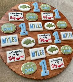 a wooden plate topped with lots of decorated cookies