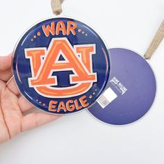 Licensed by Auburn University *Please allow 3-5 business days in addition to regular processing time for this item* Deck the halls with Auburn pride this holiday season with an ornament that is the perfect way to show off your school spirit and bring a touch of Tiger tradition to your festive decorations. This shiny, clear acrylic ornament is a digital print by New Orleans' artist Kristin Malone. Ornament measures 4" wide x 4" tall x 1/8" thick. Hangs approximately 6" with ribbon. See all of the Auburn Door Hangers, Auburn Logo, Diy Xmas Ornaments, Ornaments Ideas, Auburn University, Auburn Tigers, Deck The Halls, Xmas Ornaments, School Spirit