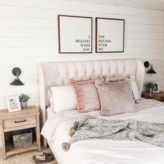 a white bed with pillows and blankets on it