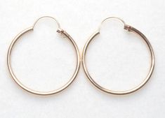 Gorgeous PETITE pair of  vintage 14k gold filled HOOP earrings.  THESE ARE OLD STOCK GOLD FILLED HOOPS  They are 20  mm round  in diameter hoops. The inside of Hoops are 17mm. These are Good Size  Hoops.   This piece is original. They made by A & Z company around 1950's.  They look and feel like real gold at the fraction of cost. Just try one piece and you will be amazed. These are roll gold and will be your best friends for  lifetime. Made by A & Z company operated from 1940- 1970's and guarant Gold Hinged Round Hoop Earrings, Gold Hinged Hoop Earrings, Vintage Gold Earrings For Everyday Wear, Everyday Vintage Round Earrings, 14k Gold Filled Round Hoop Earrings For Formal Occasions, Formal 14k Gold Filled Round Hoop Earrings, Vintage Round Hypoallergenic Jewelry, Vintage Nickel-free Hoop Earrings For Everyday, Vintage Small Hoop Tarnish Resistant Jewelry