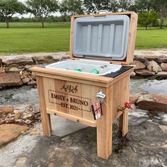 an ice chest sitting on top of a rock covered ground