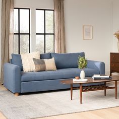 a living room with a blue couch and coffee table