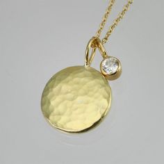 "Beautifully crafted Diamond and 14ky gold pendants on a 16\" 14ky gold chain. Hammered disc is about 1/2 of an inch in diameter. Diamond is a 3mm SI1. Very contemporary, classy, and timeless. Birthstone for April. Comes with a lifetime warranty, polishing cloth, and a gift box." Elegant Luxury Hammered Chain Necklace, Yellow Gold Necklace With Round Stone For Everyday, Everyday Yellow Gold Necklace With Round Stone, 14k Gold Round Coin Necklace Fine Jewelry, Yellow Gold Plated Round Coin Necklace, Yellow Gold Plated Coin Necklace With Round Shape, 14k Gold Round Coin Necklace, Yellow Gold Hammered Round Disc Necklace, Yellow Gold Coin Pendant Necklace