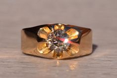 a gold ring with a diamond in the center