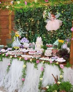 a table topped with lots of cake and cupcakes