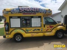 an ice cream truck is parked in front of a house with the door open and windows painted yellow