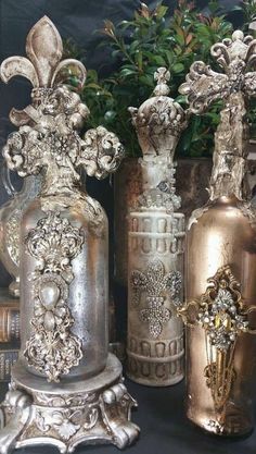 three ornate vases are sitting next to each other