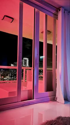 an open window with purple curtains and city lights in the background