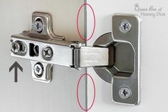 an image of the latch on a door that is closed and has four screws