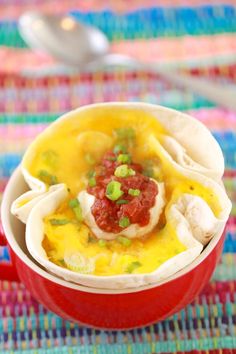 a red bowl filled with food on top of a table