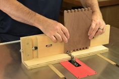 a man is working on a piece of wood