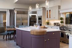 a large kitchen with an island in the middle