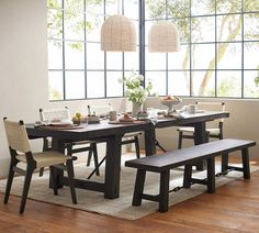 a dining room table with two benches in front of it