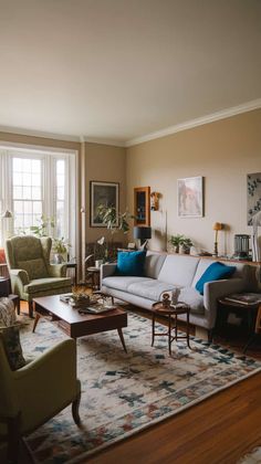 a living room filled with furniture and a large rug on top of a hard wood floor