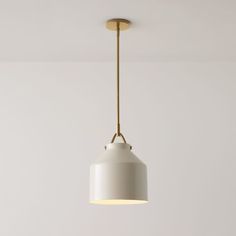 a white light hanging from a ceiling in a room